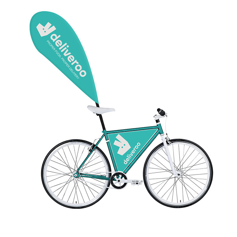 White fixed-gear city bike with a branded teal promotional flag