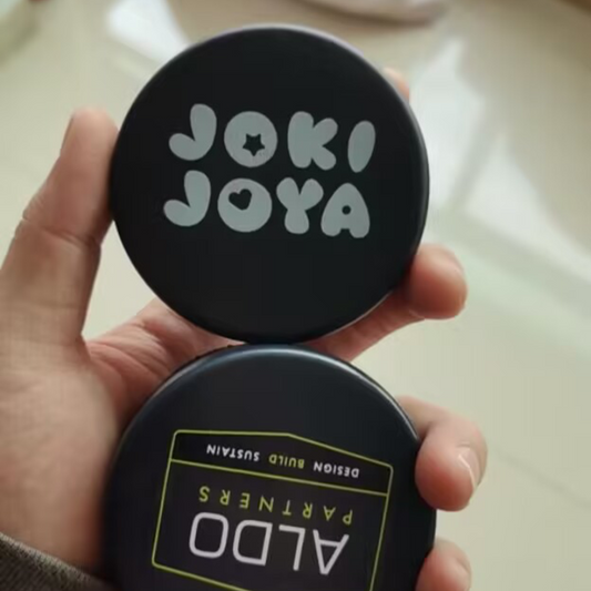 Black regulation ice hockey pucks with white printed logos