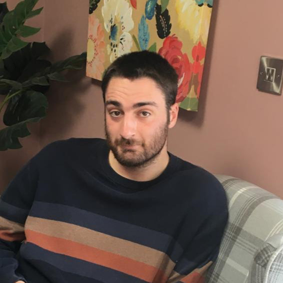 Jenson Price, creative and media director at Swish & Click, seated indoors with a confident expression — the imaginative mind behind the company’s branded storytelling and visual campaigns.